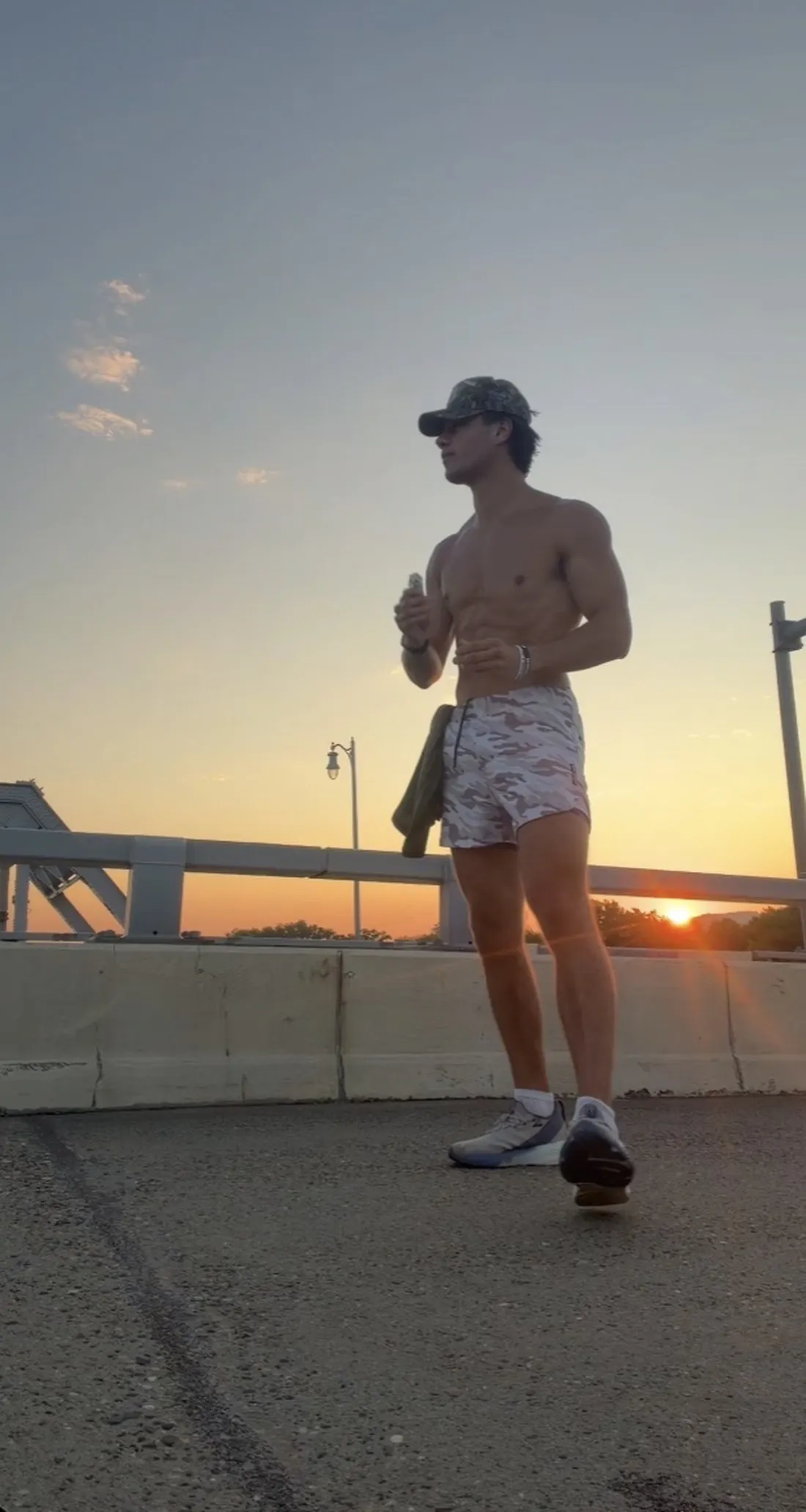Coach walking outdoors at sunset